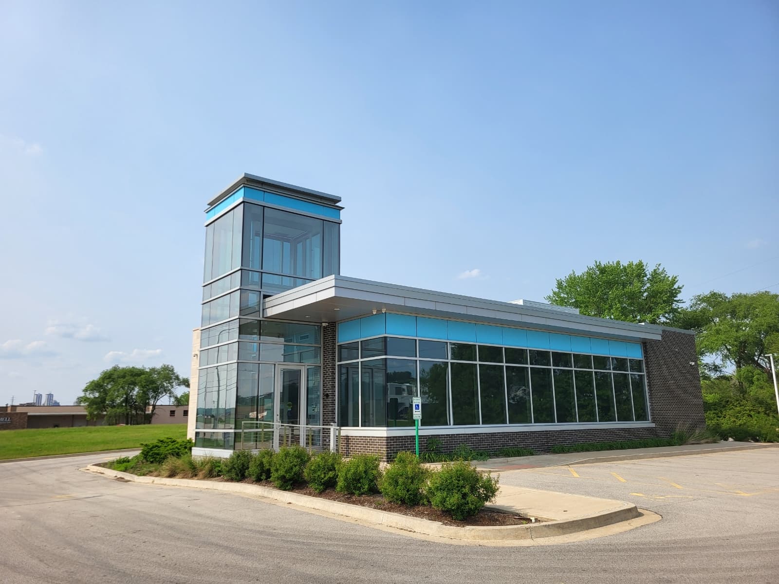 Commercial storefront glazing reinforced with security window film and structural silicone attachment