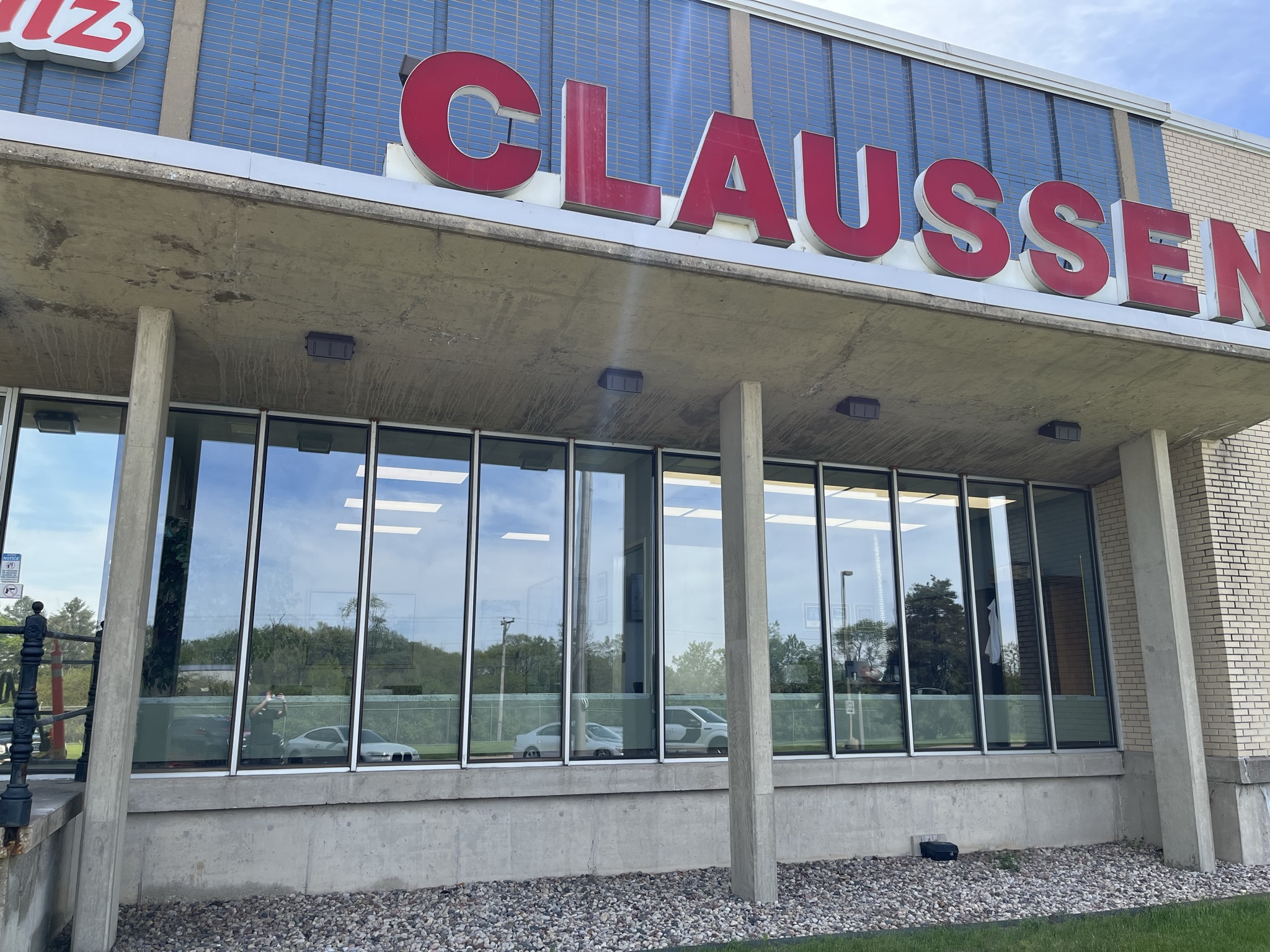 Reflective solar control window film on the lobby glass of the Claussen plant in Woodstock, Illinois.