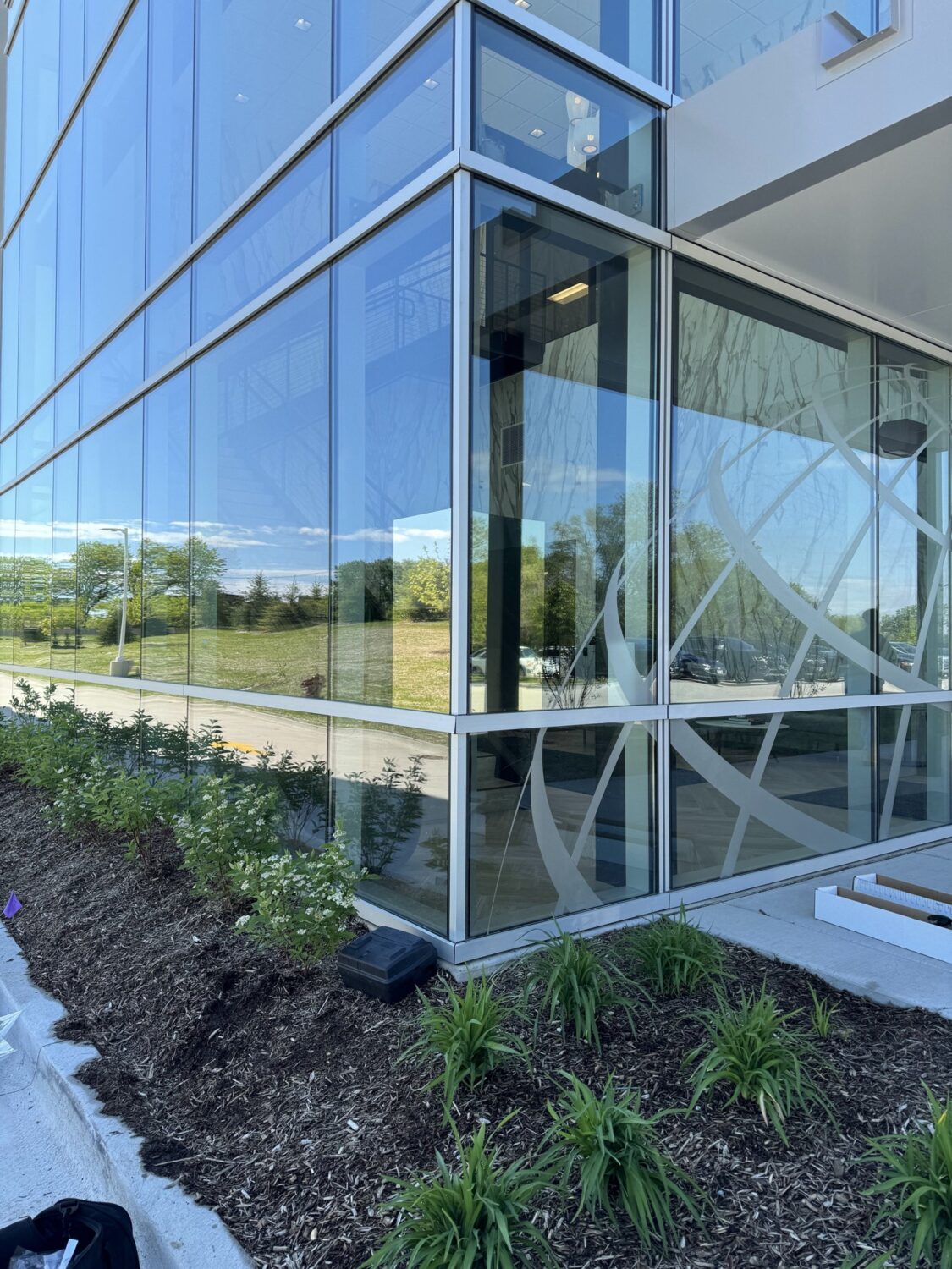 Corner of the glass curtain wall at the AIT Logistics office, seen from outside, part of the window film project.