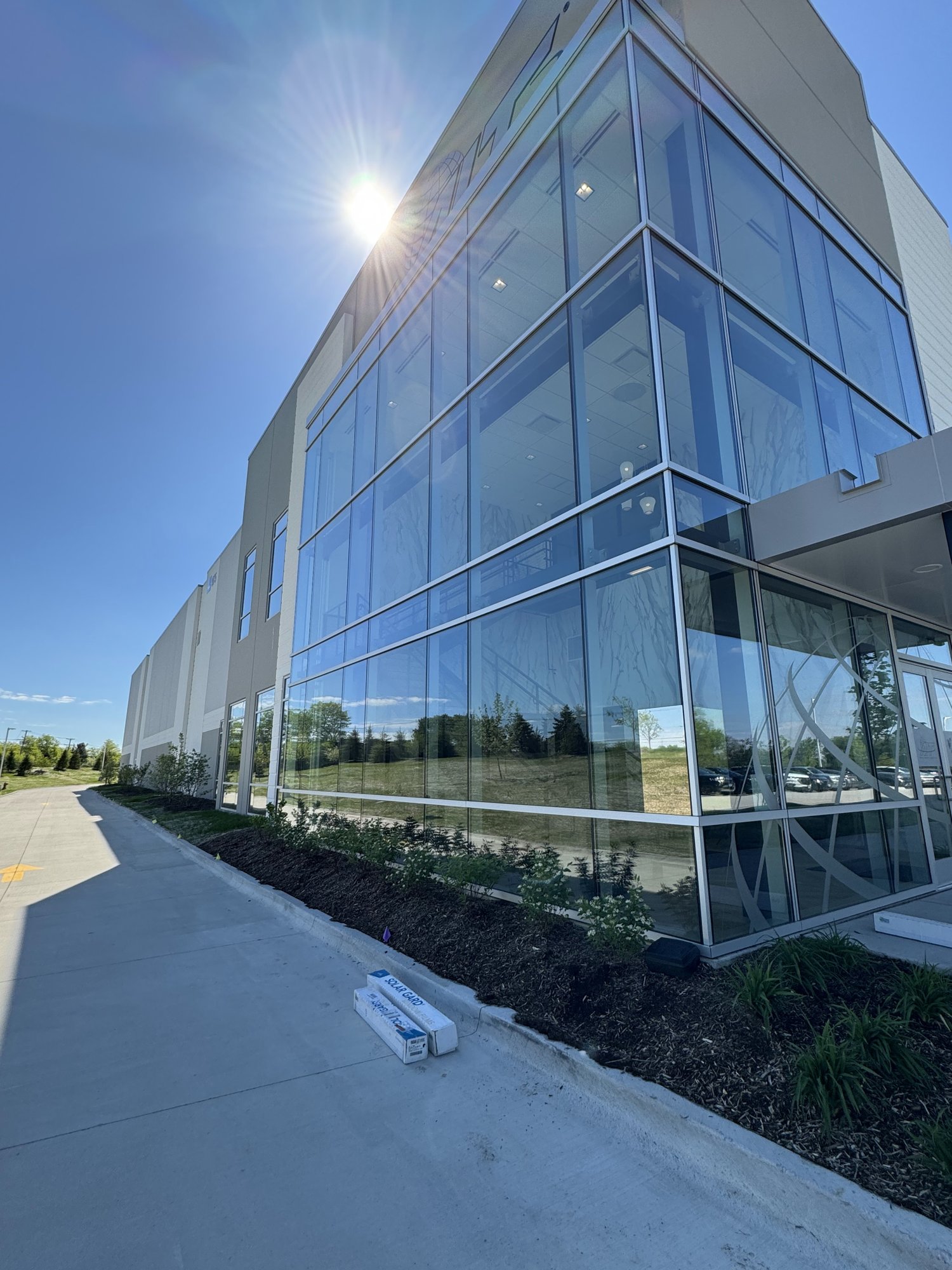 Long glass wall of the AIT Logistics office in direct sun, the heat and glare the window film was installed to reduce.