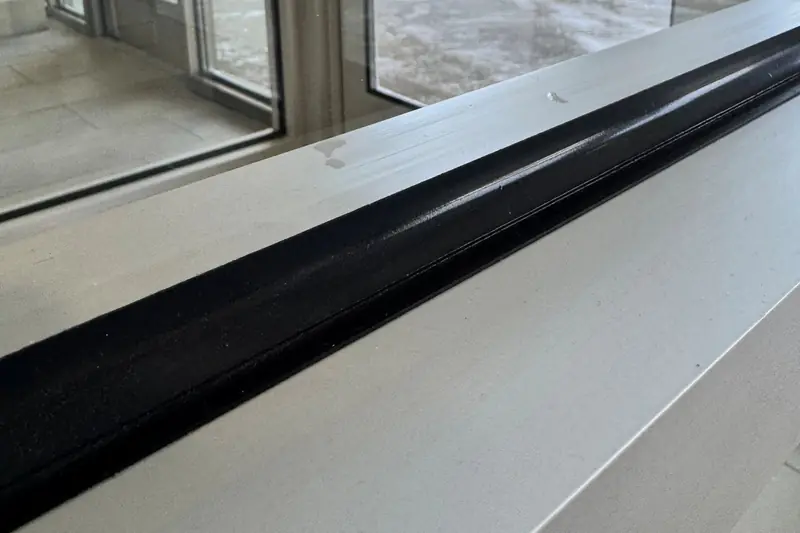 Security window film on a government facility window in Northern Illinois, attached to the frame with a continuous bead of DOWSIL 995 structural silicone.