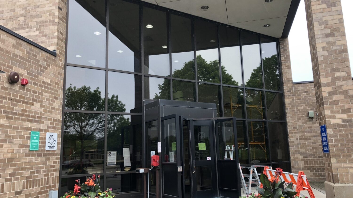 Two-story glass entrance of the Naperville Police Department with Solar Gard Sentinel Plus exterior window film installed by AAA Glass Tint in 2019.